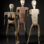 Sukuma dance figures (52, 60, and 56 inches tall) made of wood, metal, and pigments. 