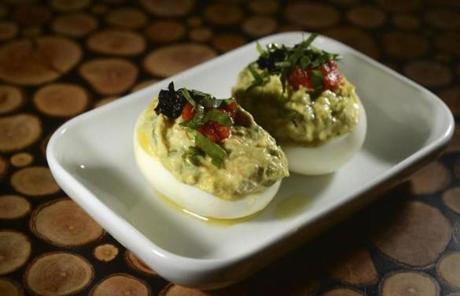 Deviled eggs with tuna and black olives added to the creamy yolk.
