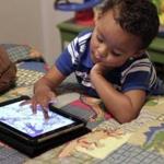 A child played with an iPad. The Campaign for a Commercial-Free Childhood challenges claims that apps for tablets and smartphones can teach young children. 