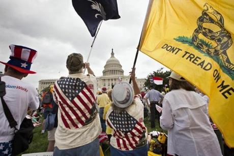 Tea Party activists, rallying at the US Capitol earlier this summer, have resurrected a strategy of using town hall forums to display their anger.
