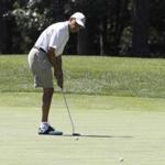 President Barack Obama putted while golfing on the first hole at Farm Neck Golf Club in Oak Bluffs, Mass., on the island of Martha's Vineyard.