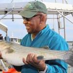 Harvard law professor Charles Ogletree admired a striped bass he caught Thursday.