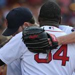 After leaving the game in the seventh, Sox starter John Lackey gets a hug from David Ortiz as he returns to the dugout.
