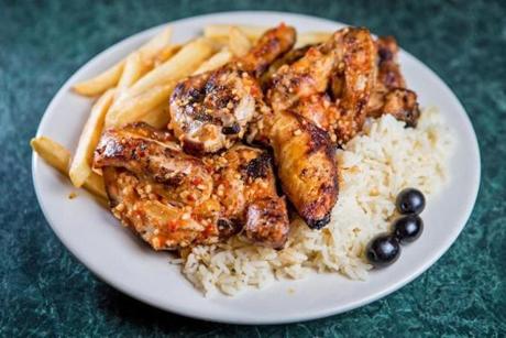 “½ frango no churrasco,” a half rotisserie barbecue chicken with fries and rice pilaf at J & J Restaurant & Takeout. 
