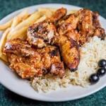“½ frango no churrasco,” a half rotisserie barbecue chicken with fries and rice pilaf at J & J Restaurant & Takeout. 