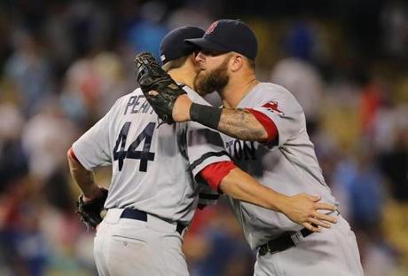 Jake Peavy celebrated with Mike Napoli after his complete-game win over the Dodgers.
