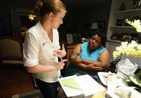 Rachel Perry (left) talked about health care enrollment with Deborah Young, who is self-employed, in Dallas.
