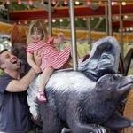 James Brunger helped his daughter, Stella, off the newly opened Rose F. Kennedy Greenway Carousel. 