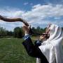 Rabbi Darby Leigh, who is deaf, practiced blowing the ceremonial shofar outside Concord’s Congregation Kerem Shalom. “I prefer the lower bassy sound,’’ he says. “I can feel it better.”   