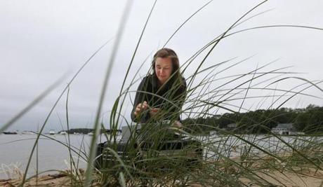 Kenly Hiller worked along the shore at the Waquoit Bay National Estuarine Research Reserve in Falmouth. Hiller is trying to raise $6,000 so she can design and study barriers that block nitrogen runoff from polluting coastal waters.
