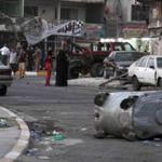 People inspect the site of a car bomb attack at the Karrada neighborhood of Baghdad.