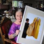 At her Wareham home, Rose Cherubini displays a photo of one of the dresses she designed. 