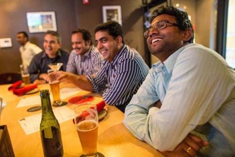 From right: Martin Mani, Brillo Babu, Arun Papineni, and Anish George work together and then watch together at Hit Wicket one Friday night in August. 
