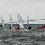 Groups of young sailors try their racing skills in Newport Harbor as part of their Sail Newport instruction.  In the background is the Claiborne Pell Bridge spanning the East Passage of Narragansett Bay. 