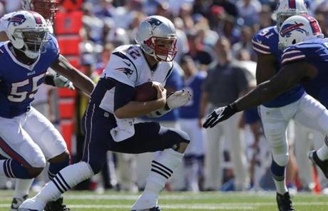 Tom Brady held on to the ball for a short gain in the first half.
