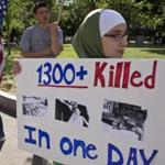 Deema Alawa, 12, of East Hampstead, N.H., held a sign on Boston Common Sunday supporting US action against Syria’s regime, a day after a protest against intervention.