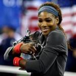 Serena Williams gives Open trophy a hug.