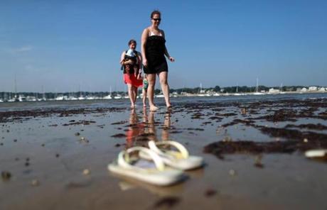 Elizabeth Watts enjoyed low tide at a Scituate beach as temperatures rose into the high 90s on Wednesday.
