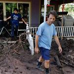 Allen Tawa and his daughter Kayla walked out of their mud-clogged home after days of flooding, on the edge of Boulder, Colo., on Saturday. Not all were willing to leave the area.