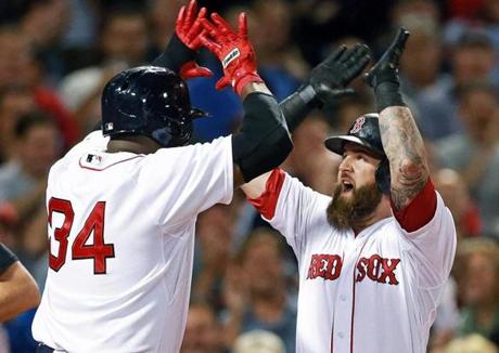 Mike Napoli was met at the plate by David Ortiz after his two-run home run in the first inning.
