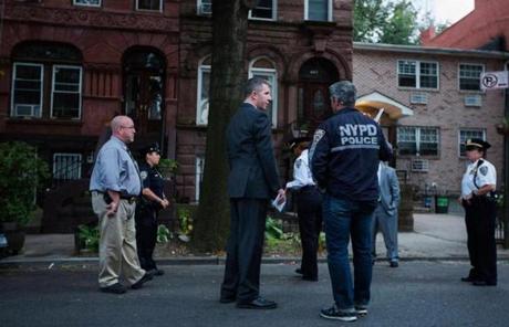 Law enforcement officers stood outside the residence of Cathleen Alexis, mother of the suspected gunman, in New York.
