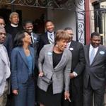 Nine prominent black ministers said Charlotte Golar Richie (front, second from left) has the experience and temperament to lead Boston.