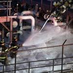 Fire crews worked to contain a fire at a fuel storage area at Logan Airport on Tuesday.