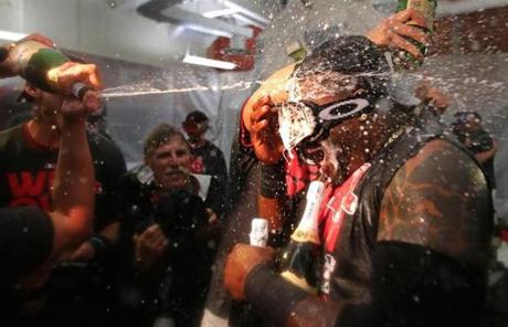 David Ortiz took a direct hit of champagne as the Red Sox celebrated clinching the AL East title with a 6-3 win over the Blue Jays.

