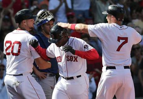 Jackie Bradley Jr. (middle) is greeted a home plate by Ryan Lavarnway (left) and Stephen Drew following his homer.
