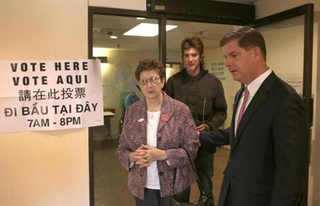 Martin Walsh helps his mother, Mary Walsh, out after she voted at the Catherine F. Clark apartment building in Dorchester.
