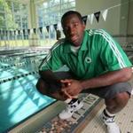 Celtics forward Brandon Bass begins swimming lessons in Waltham Friday along with youths from the Boys and Girls Club.