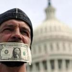 A protester’s mouth was covered with a dollar bill during a demonstration in front of the US Capitol.