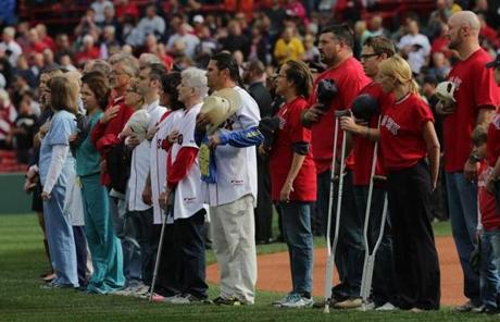First responders and family members of those injured or killed in the Boston Marathon bombings were honored before the game
