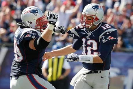 Offensive run blocking by Logan Mankins (left) and his Patriots linemates creates balance and makes life a lot easier for Tom Brady.
