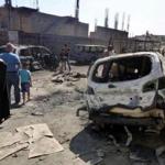 Iraqis inspect the site of bombing attack near a Shiite mosque in eastern Baghdad.