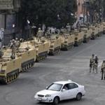 Egyptian soldiers took positions on top and next to their armored vehicles to guard an entrance of Tahrir Square, in Cairo, on Aug. 16.