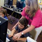 Second-grade teacher Kimberly Blackert helped Cody Simpson with his touch typing at Horseshoe Trails Elementary School in Phoenix.