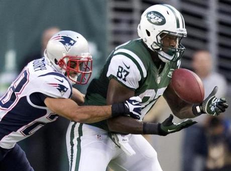 The Patriots’ Steve Gregory put pressure on Jets receiver Jeff Cumberland for an incomplete pass in the second half.
