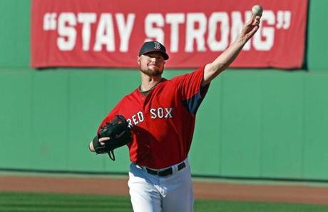 Jon Lester threw in the outfield during practice at Fenway Park on Monday.
