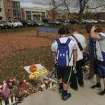 Students walked in front of a make-shift memorial at Danvers High School.