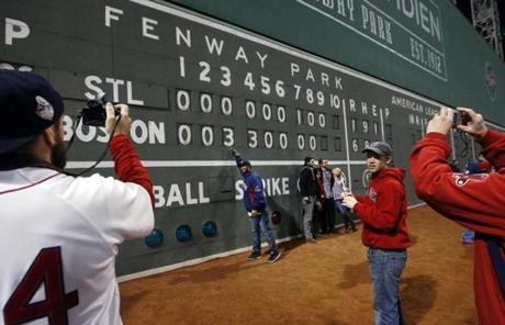 Fans took pictures of the Fenway Park scoreboard following the Red Sox victory.

