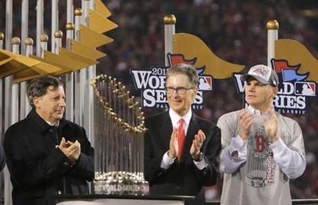 Team chairmanTom Werner, principal owner John Henry, and general manager Ben Cherington are seen with the trophy.
