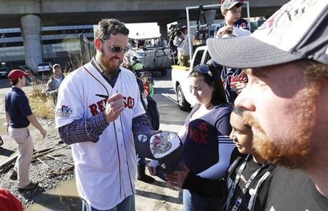 John Lackey signed a hat before the duck boats entered the Charles River.
