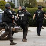 SWAT officers rushed toward a Watertown house in the search for alleged Marathon bomber Dzhokhar Tsarnaev in April.