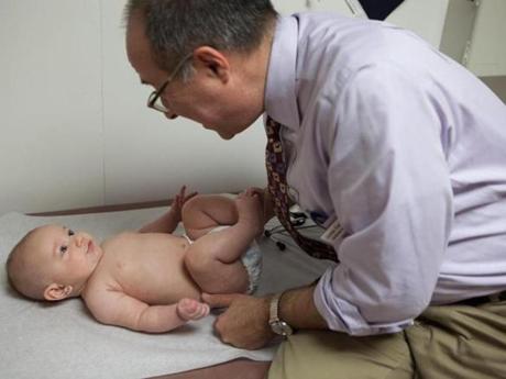 Dr. John Snyder, examining 4-month-old Jacob at Amherst Pediatrics, is fighting to convince parents that their children need to be vaccinated.
