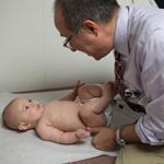 Dr. John Snyder, examining 4-month-old Jacob at Amherst Pediatrics, is fighting to convince parents that their children need to be vaccinated.