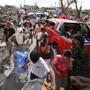 Survivors of Typhoon Haiyan filled the streets as they looked for supplies in downtown Tacloban in the central Philippines on Monday.