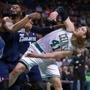 Kelly Olynyk of the Celtics bent over as he battled for position under the boards with Charlotte's Al Jefferson.