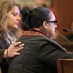 Erin Manning rubbed the back of domestic worker Sonia Soares during her testimony at the State House Tuesday.