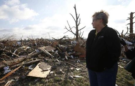 Pat Nelson looked out over the debris and destruction caused by a tornado that touched down in Washington, Ill.
